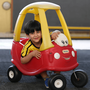 Child in toy car